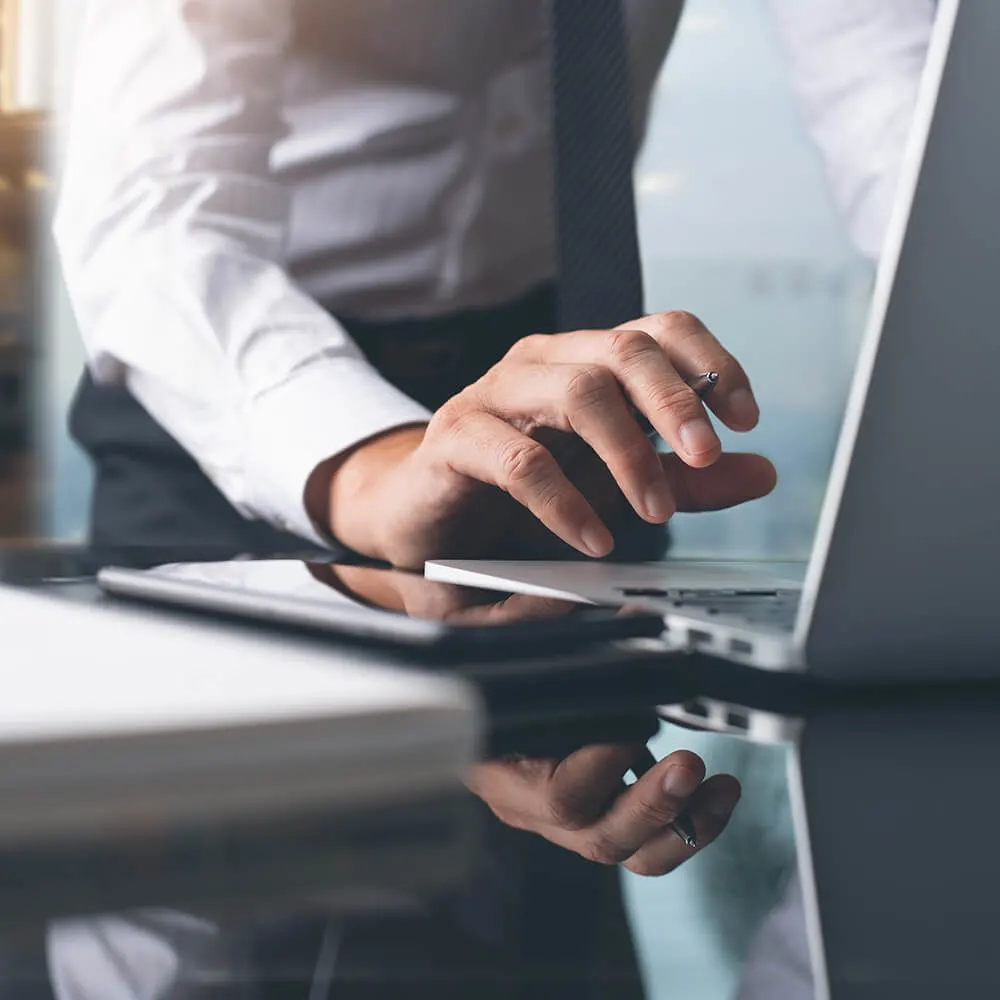 Businessman typing at a computer